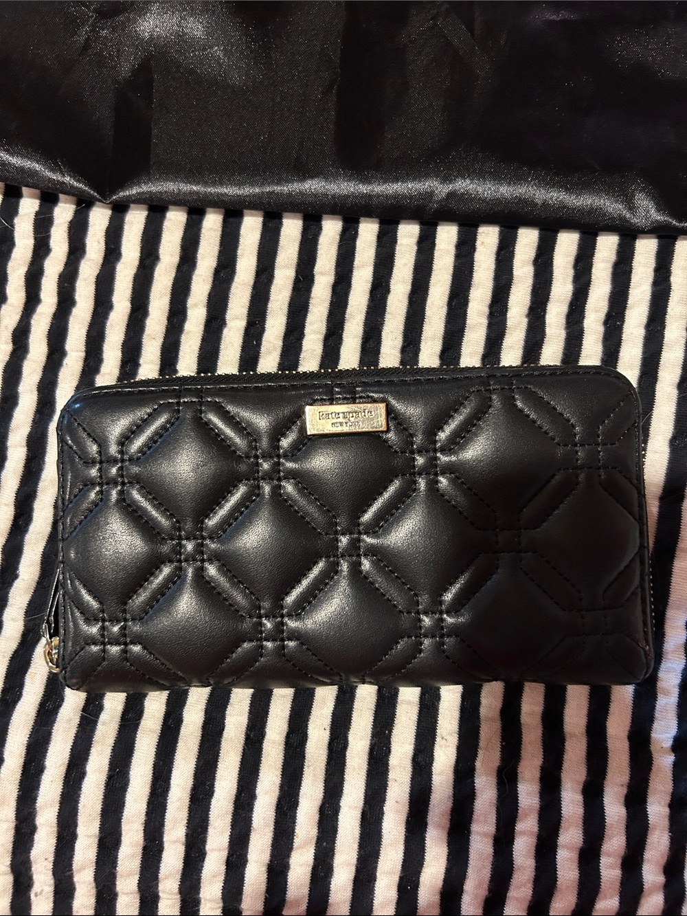 kate spade black quilted zip-around wallet with gold plaque